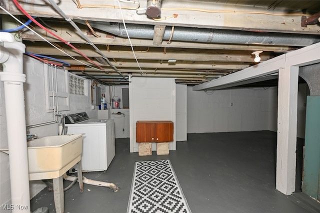 basement featuring washer and dryer and sink