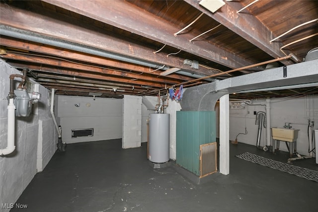 basement featuring water heater and sink