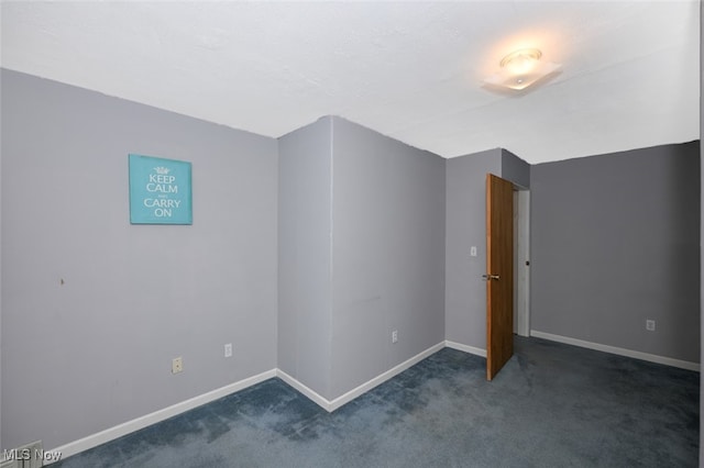 unfurnished bedroom featuring dark colored carpet