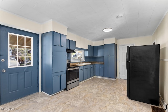 kitchen with electric range, black refrigerator, sink, and blue cabinetry