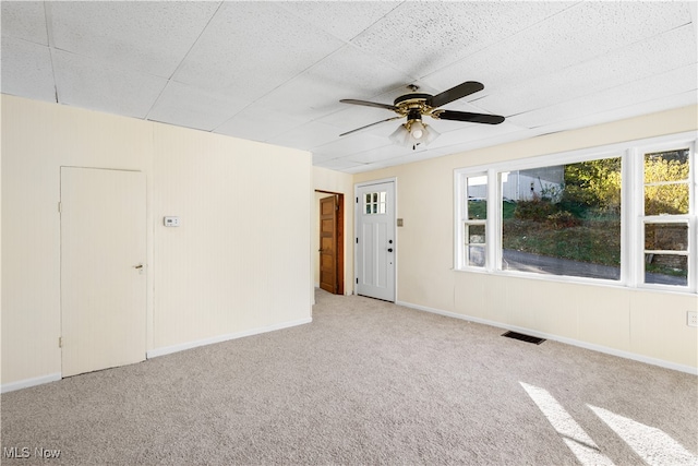 carpeted spare room featuring ceiling fan