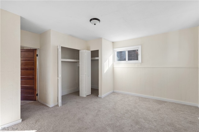 unfurnished bedroom featuring light carpet