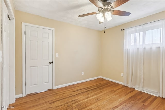 unfurnished bedroom featuring ceiling fan and light wood-type flooring