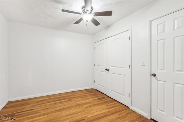 unfurnished bedroom featuring light hardwood / wood-style flooring and ceiling fan