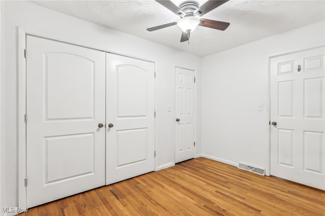 unfurnished bedroom featuring ceiling fan and light hardwood / wood-style floors