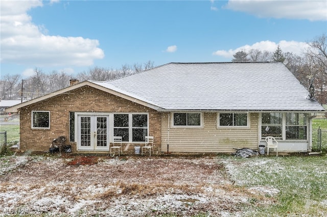 back of property with french doors and a sunroom