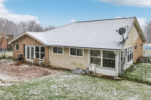 back of house featuring a sunroom and a yard