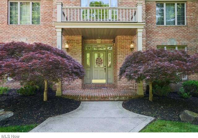 entrance to property featuring a balcony