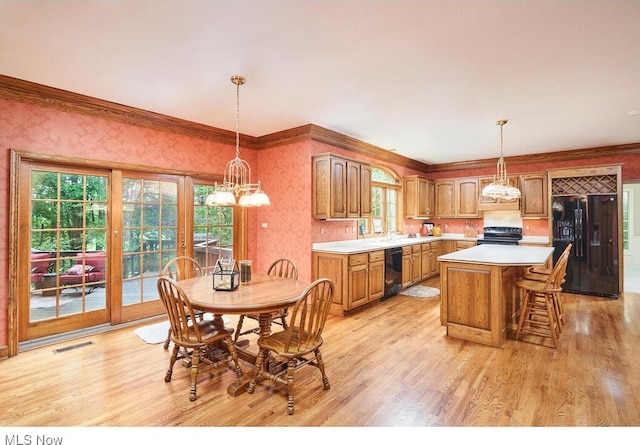 dining space with light hardwood / wood-style floors and crown molding