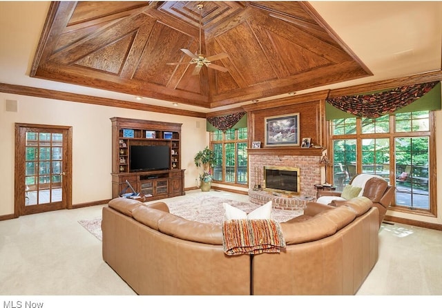 carpeted living room featuring coffered ceiling, ceiling fan, ornamental molding, a fireplace, and wood ceiling