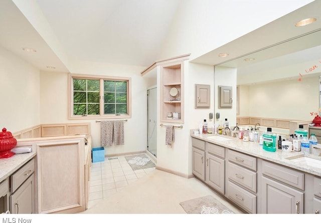 bathroom with vanity, tile patterned floors, and a shower with door