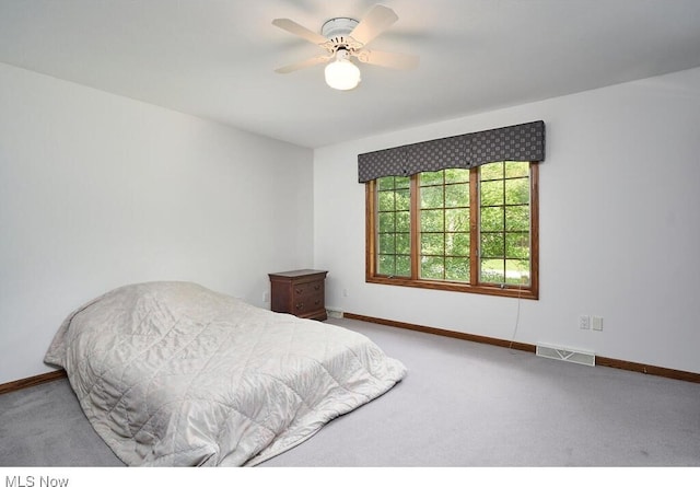 bedroom with light carpet and ceiling fan