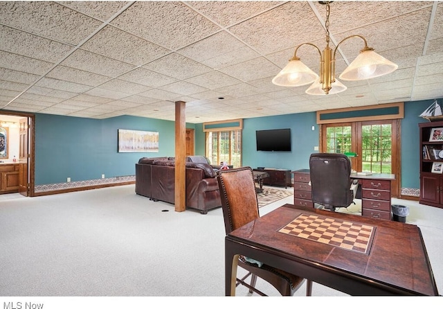 carpeted dining room with french doors and a paneled ceiling