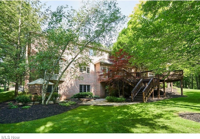 exterior space featuring a deck and a lawn