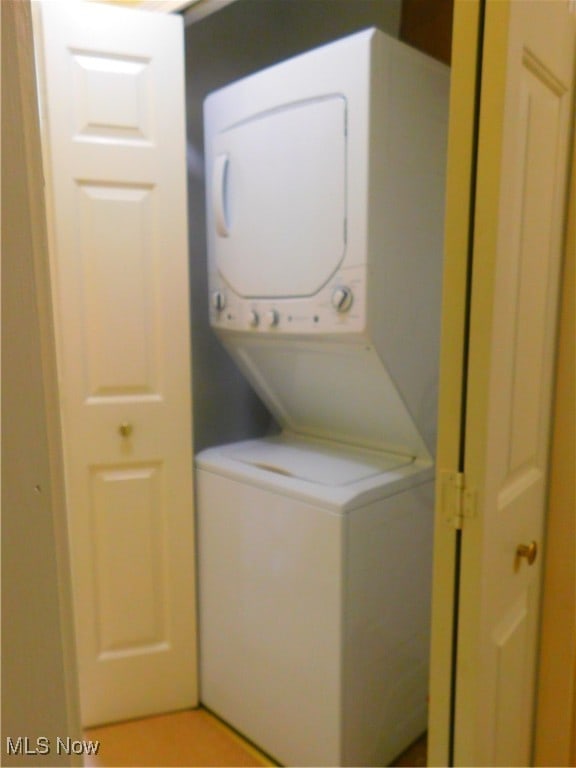 laundry area with stacked washer / dryer