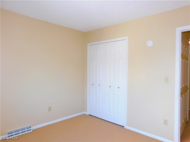 unfurnished bedroom featuring a closet and carpet