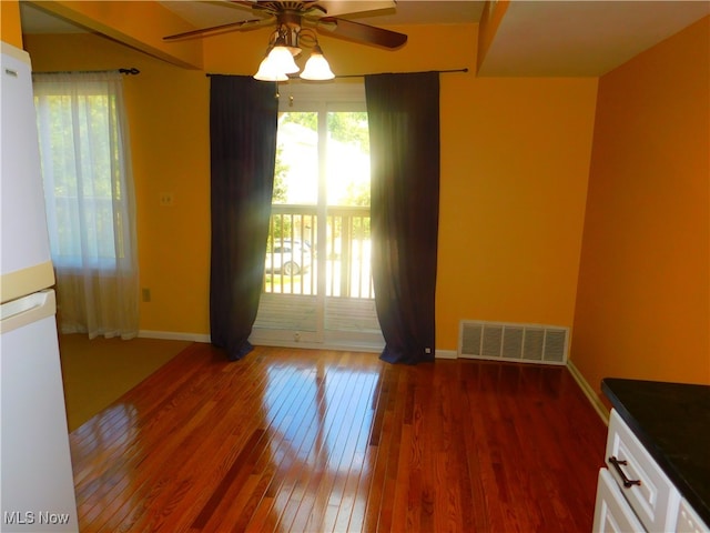 unfurnished room featuring ceiling fan and dark hardwood / wood-style floors