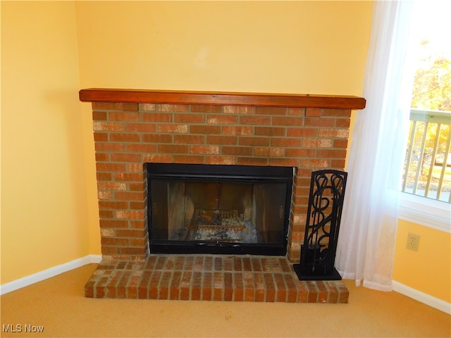 interior details with carpet floors and a brick fireplace