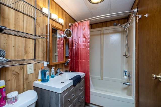 full bathroom with wood walls, shower / tub combo with curtain, vanity, and toilet