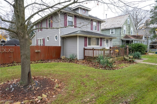 exterior space featuring a deck and a lawn