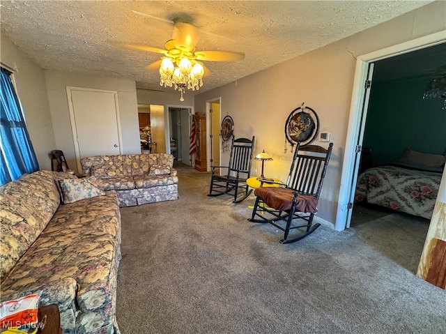 living room featuring carpet flooring, ceiling fan, and a textured ceiling