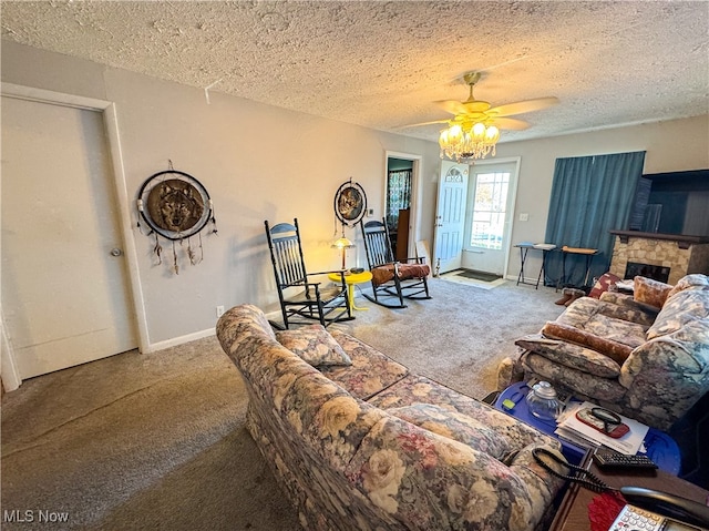 carpeted living room featuring ceiling fan, a fireplace, and a textured ceiling