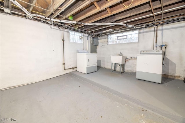 basement with washing machine and dryer and sink