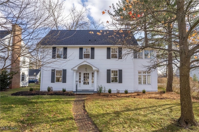 colonial home with a front lawn