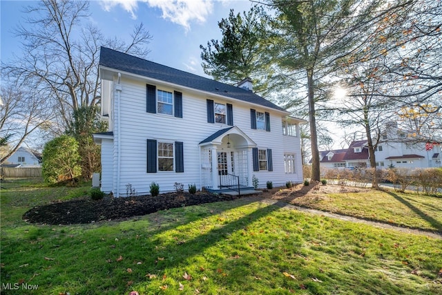 colonial home with a front lawn