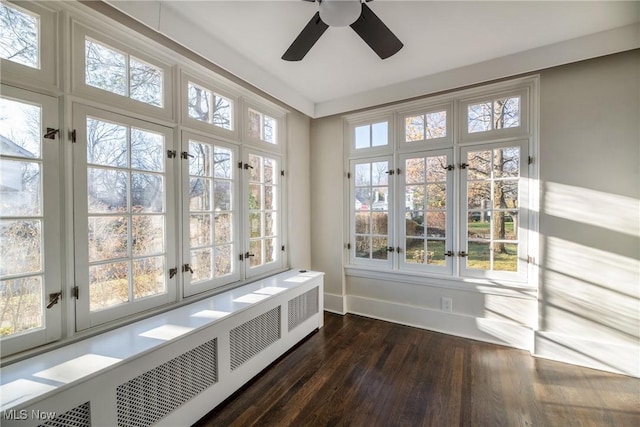 unfurnished sunroom featuring radiator heating unit