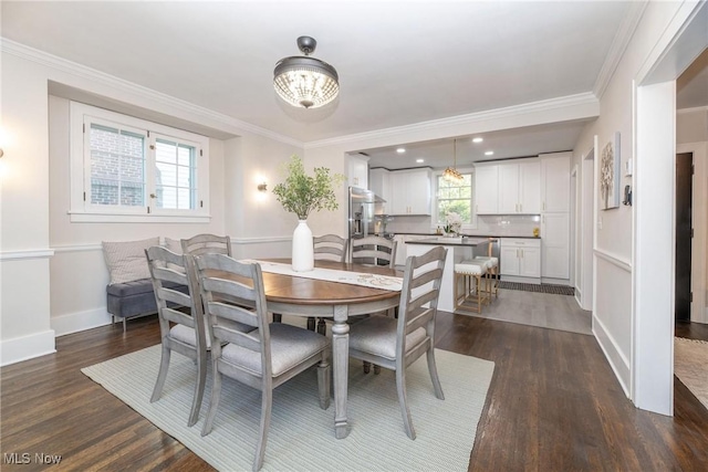 dining room with dark wood-type flooring and crown molding