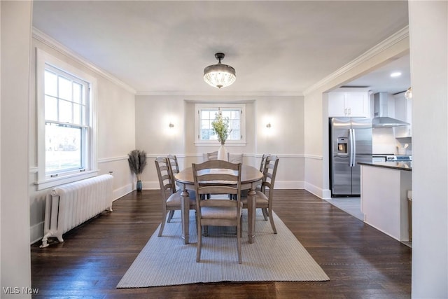 dining space featuring radiator, ornamental molding, and dark wood-type flooring