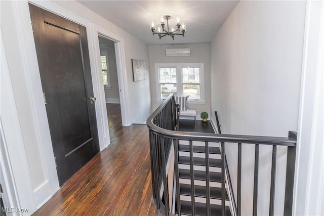 corridor with a wall mounted air conditioner, a chandelier, and dark hardwood / wood-style flooring