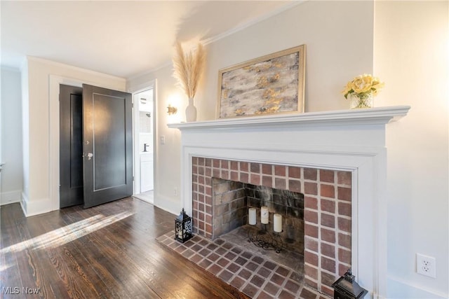 room details featuring ornamental molding, a tile fireplace, and wood-type flooring