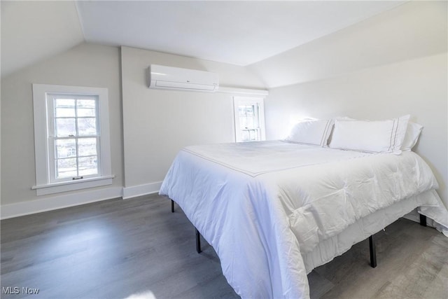 bedroom featuring lofted ceiling, a wall mounted air conditioner, and dark hardwood / wood-style flooring