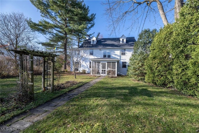 back of property featuring a yard and a sunroom