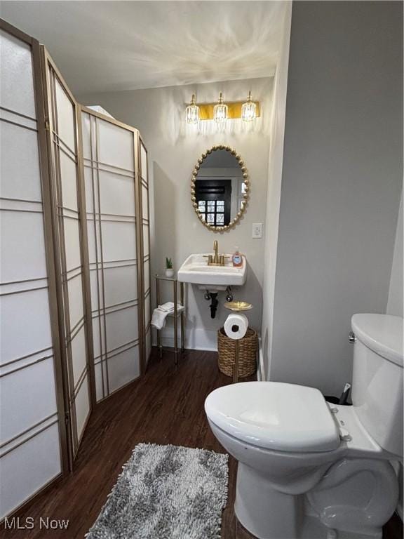 bathroom featuring sink, toilet, and wood-type flooring