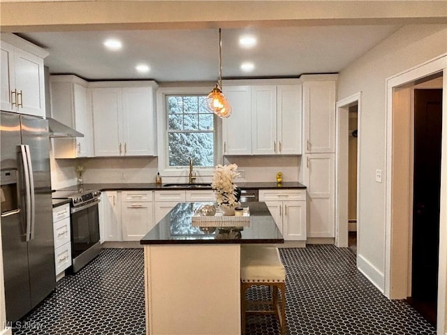 kitchen with white cabinetry, a kitchen island, stainless steel appliances, and pendant lighting