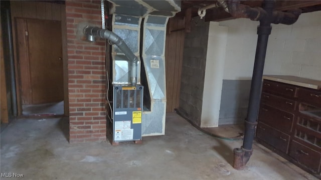 utility room featuring heating unit