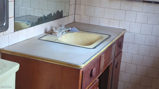 bathroom with decorative backsplash and vanity