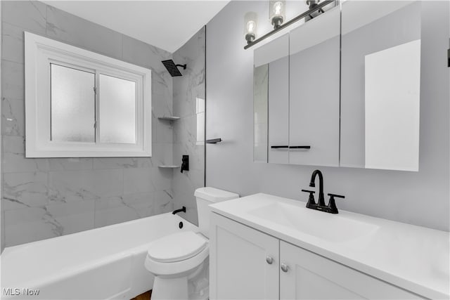 full bathroom with vanity, tiled shower / bath combo, and toilet