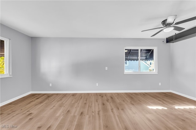 empty room with light wood-type flooring and ceiling fan