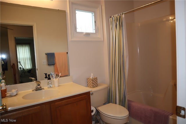 full bathroom featuring shower / bath combo, vanity, and toilet