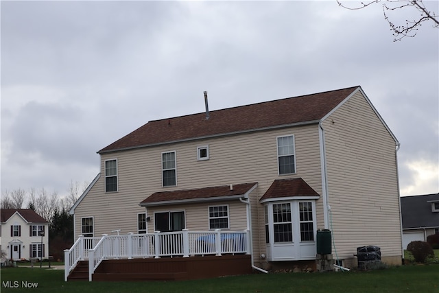 rear view of house featuring a deck