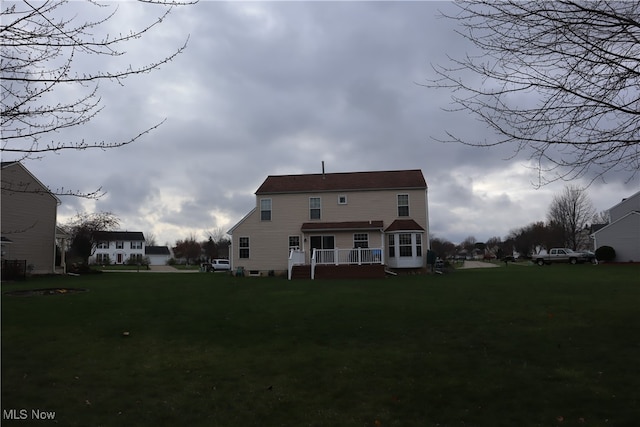 back of house featuring a yard