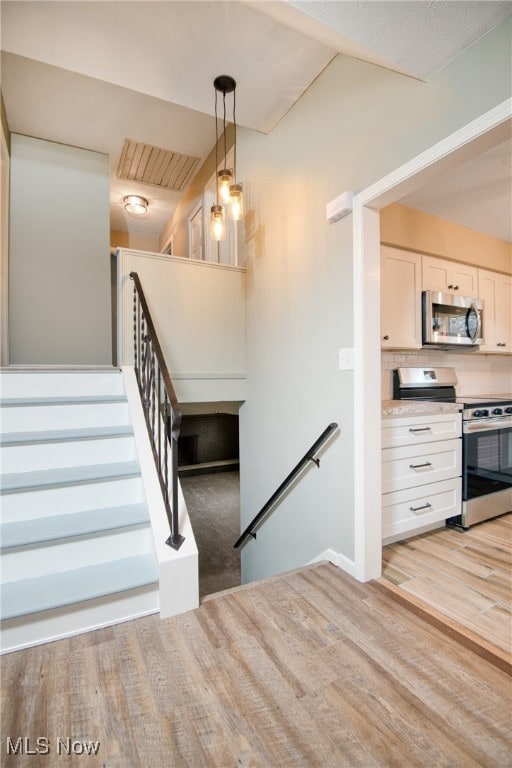 stairs with hardwood / wood-style flooring