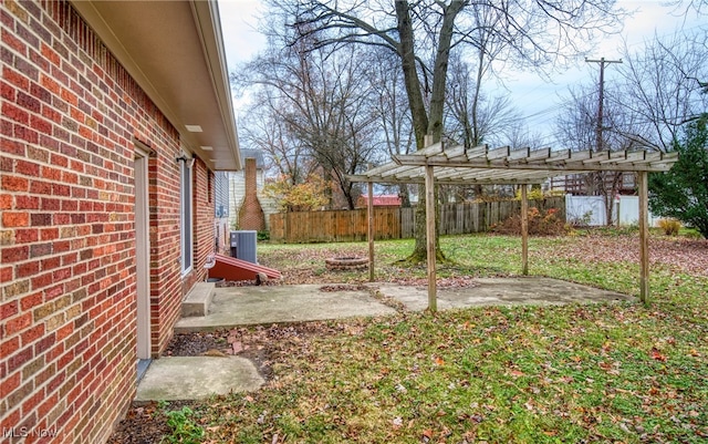 view of yard with a pergola, central AC, and a patio