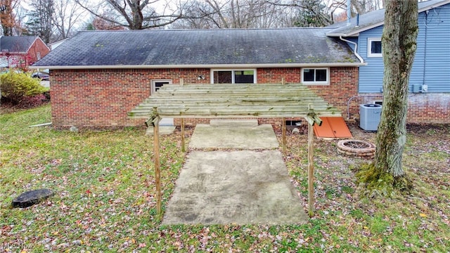 back of house featuring central AC unit