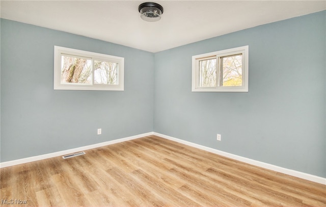 spare room featuring light hardwood / wood-style flooring