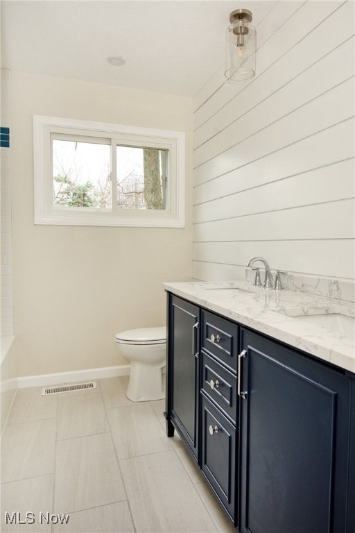 bathroom featuring vanity and toilet